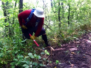 Josh McVey creates a drainage spot on the Lake Henry Loop to allow water to flow off the trail in a sustainable manner.